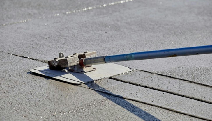 Which tool is used to cut control joints in concrete to reduce cracking as it dries?