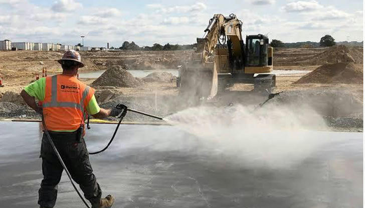 During hot weather, which action helps prevent concrete cracking?